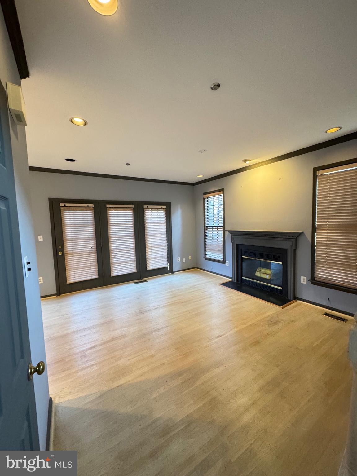 1713 Leighton Wood Lane Silver Spring, MD 20910 - Photo 18 of 47 a view of an empty room with a fireplace and a window