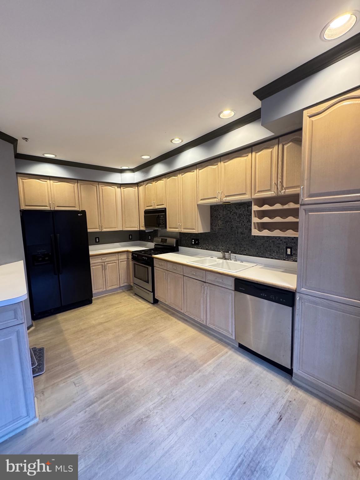 1713 Leighton Wood Lane Silver Spring, MD 20910 - Photo 22 of 47 a large kitchen with stainless steel appliances granite countertop a refrigerator and a stove top oven