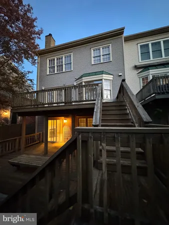 a view of a house with backyard and deck