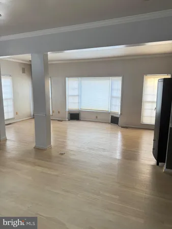 a view of a livingroom with an empty space and a window