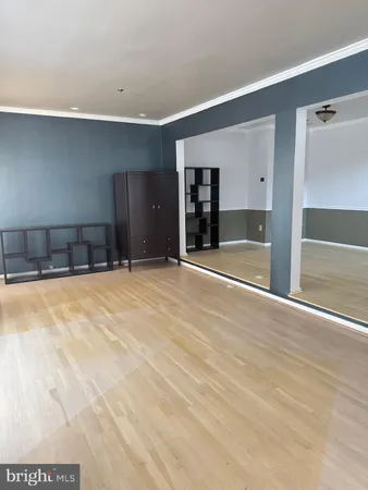 a view of an empty room with closet and a window