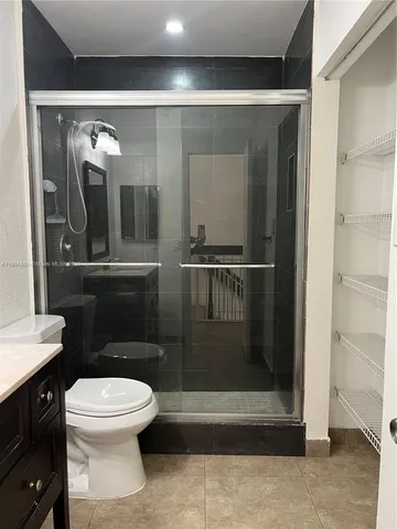 a bathroom with a toilet and a shower