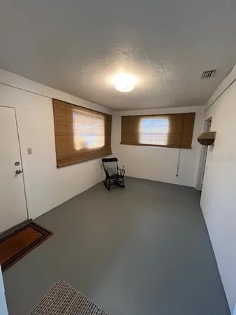 a view of room with gym equipment and windows