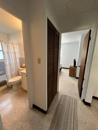 a view of a hallway with toilet and a window