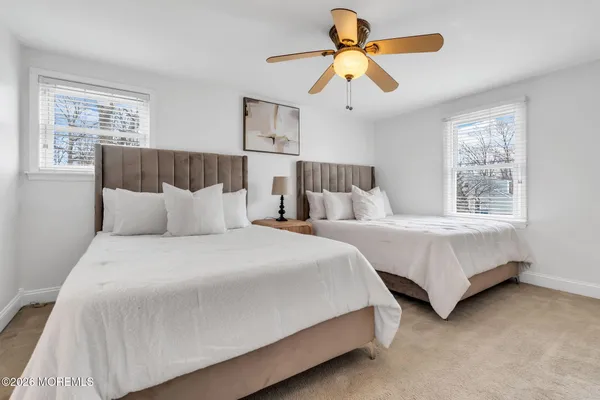 a bedroom with bed and a chandelier