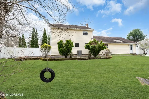 a view of a house with backyard and a garden