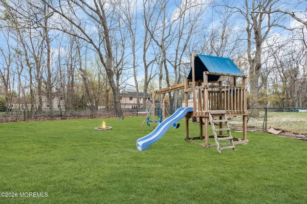 a view of a house with a backyard and a slide