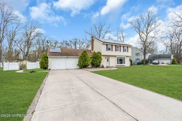 a front view of house with yard and green space