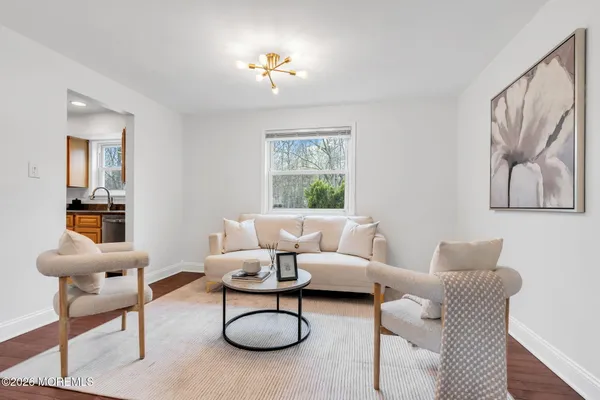 a living room with furniture a rug and a window