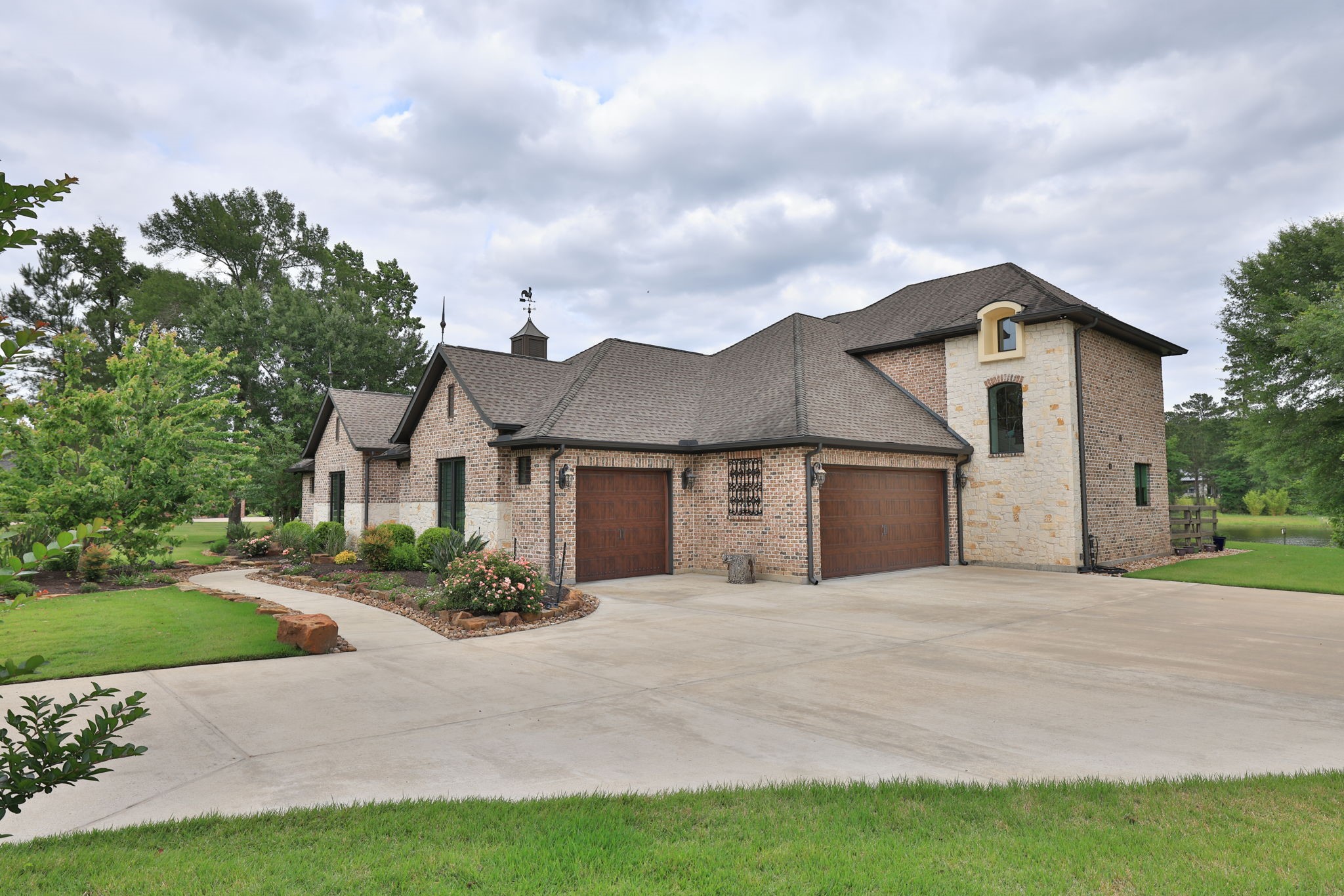 6918 Comanche Bend Montgomery, TX 77316 - Photo 9 of 50 Three oversized garage spaces with EV CHARGING, epoxy-coated floors, garage door openers, and great storage space. Additional parking is a bonus!