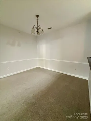 an empty room with a ceiling fan and a window