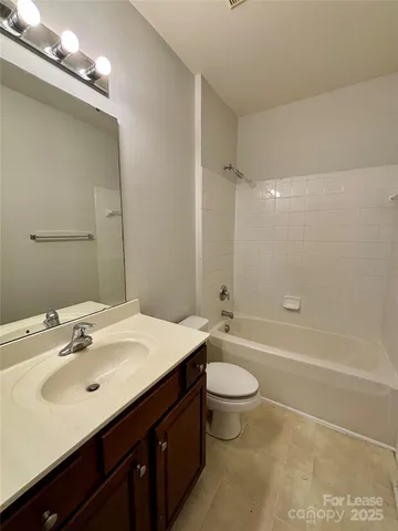 a bathroom with a sink a toilet a mirror and bathtub