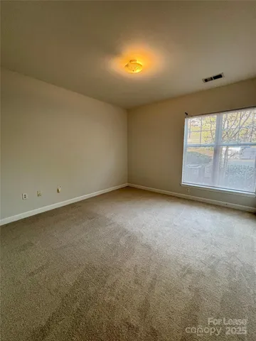 an empty room with a empty space and windows