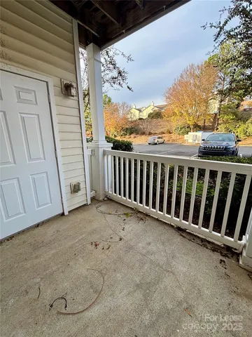 a view of a porch with wooden floor and fence