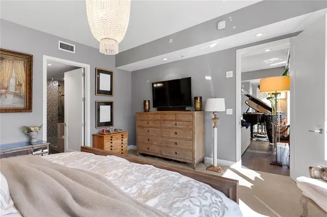 a bedroom with furniture and a flat screen tv