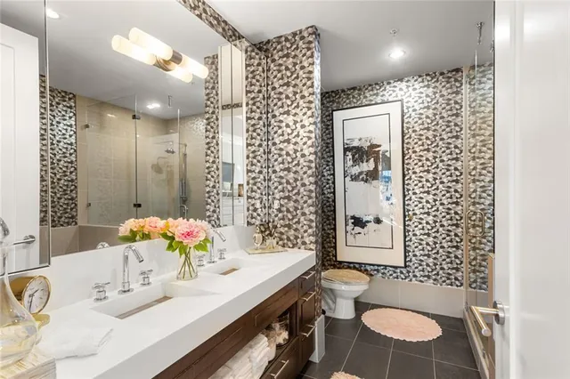 a bathroom with a sink toilet and shower