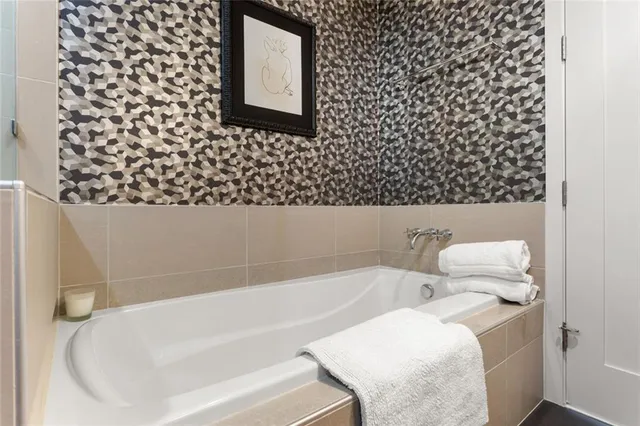 a bathroom with a bathtub and shower