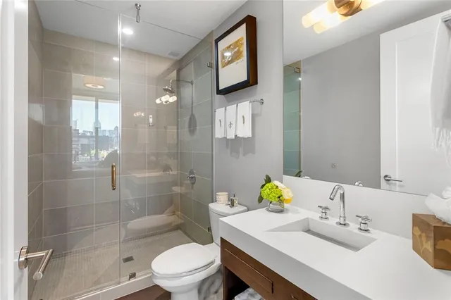 a bathroom with a sink toilet and shower