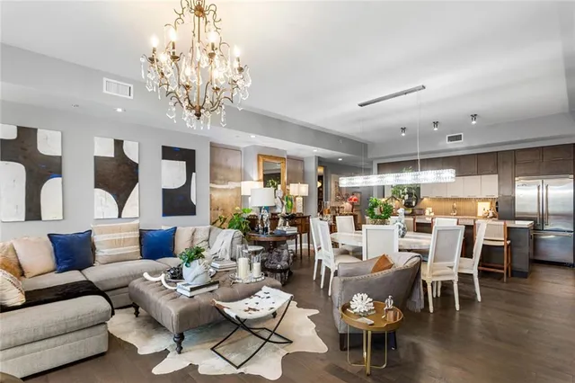 a living room with furniture or kitchen and a chandelier