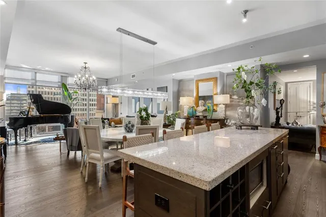 a kitchen with a table chairs and wooden floor