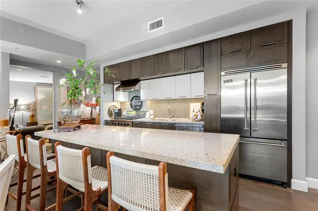 a kitchen with a table chairs refrigerator and cabinets