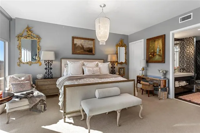 a bedroom with furniture and a mirror