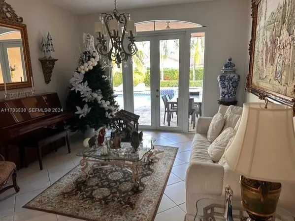 a living room with furniture and a floor to ceiling window