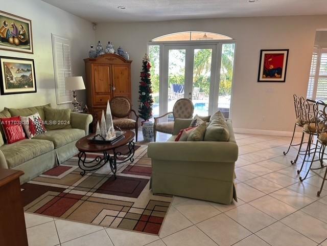 10601 Southwest 128th Street Miami, FL 33176 - Photo 12 of 30 a living room with furniture and a floor to ceiling window