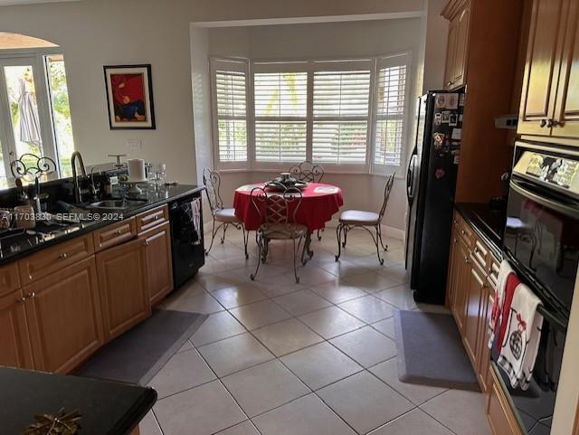 10601 Southwest 128th Street Miami, FL 33176 - Photo 18 of 30 a kitchen with stainless steel appliances a sink stove and cabinets