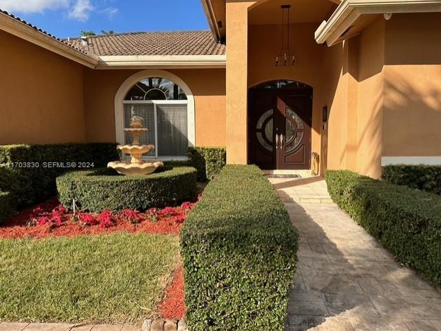 10601 Southwest 128th Street Miami, FL 33176 - Photo 2 of 30 a front view of a house with a yard