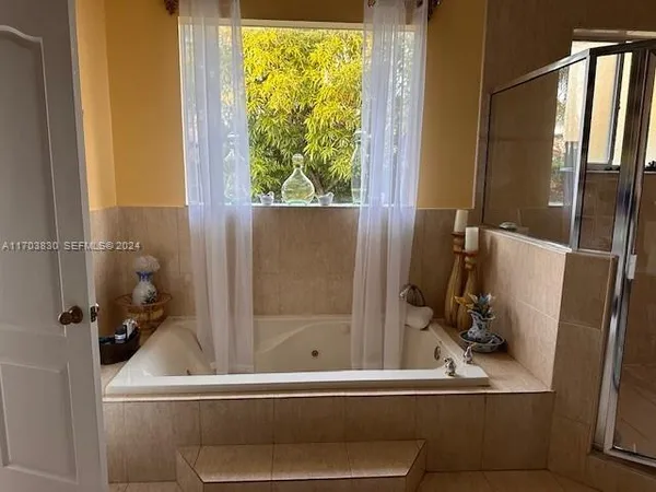 a bathroom with a double vanity sink mirror and shower
