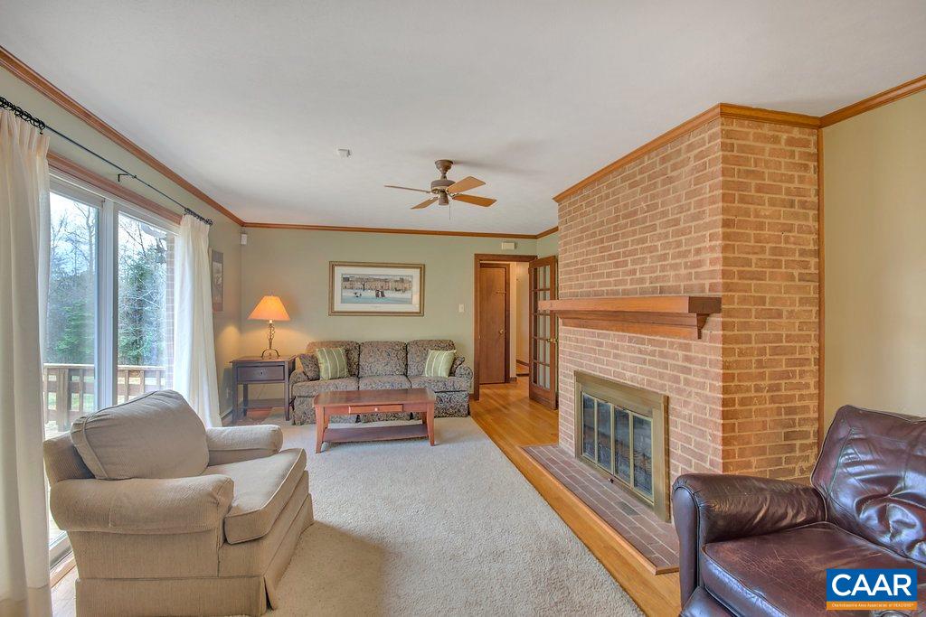 2163 Gold Mine Road Palmyra, VA 22963 - Photo 20 of 49 a living room with furniture a fireplace and a large window