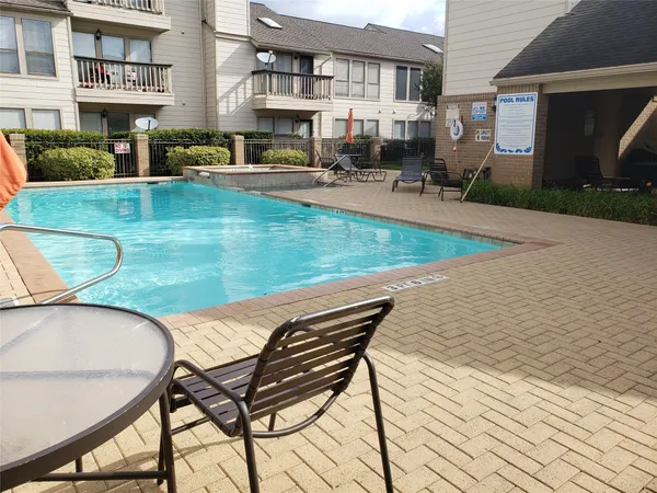a living room with fireplace furniture and a floor to ceiling window