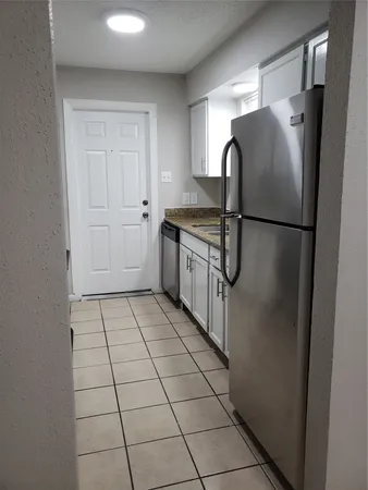 a kitchen with a refrigerator and a sink
