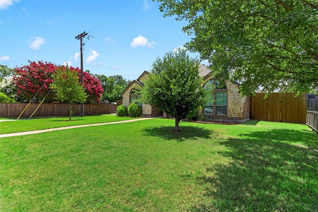 8014 Garner Road Rowlett, TX 75088 - Photo 4 of 39 a view of a house with a yard and a tree