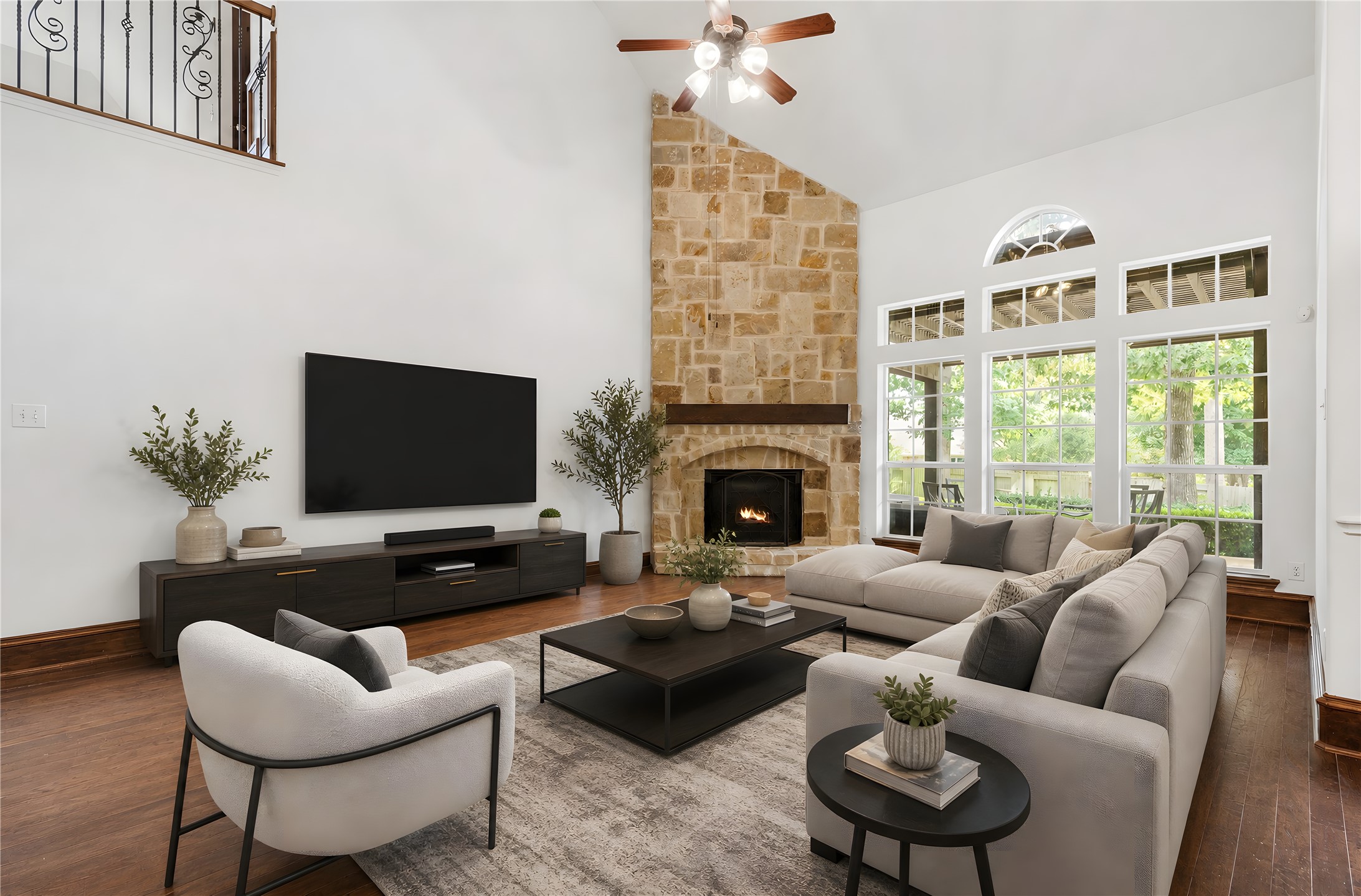 2115 Graystone Ridge Drive Conroe, TX 77304 - Photo 12 of 47 Grand family room with soaring ceilings and a magnificent floor-to-ceiling stone fireplace creates an inviting atmosphere for family and guests alike.