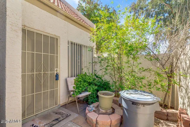 a view of a patio with table and chairs and potted plants