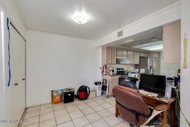 a view of a workspace with furniture and a window