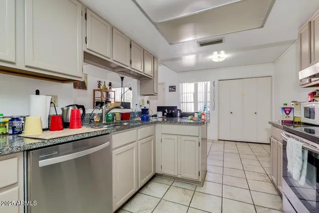 a kitchen with stainless steel appliances granite countertop a sink and cabinets