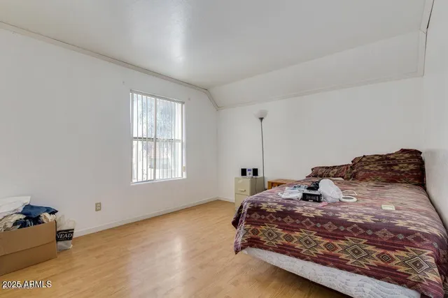 a bedroom with a bed and a window