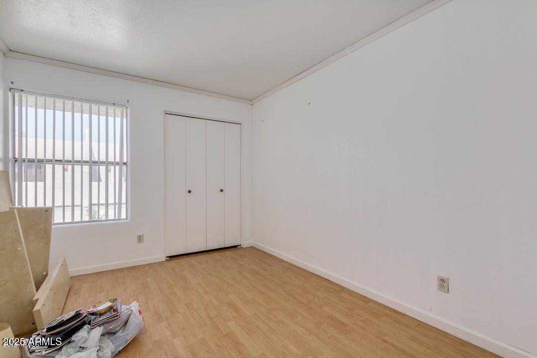 1342 West Emerald Avenue, Unit 329 Mesa, AZ 85202 - Photo 10 of 12 an empty room with a window