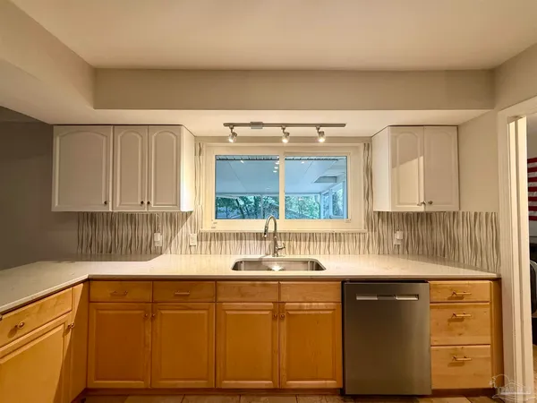 a kitchen with granite countertop a sink and a window