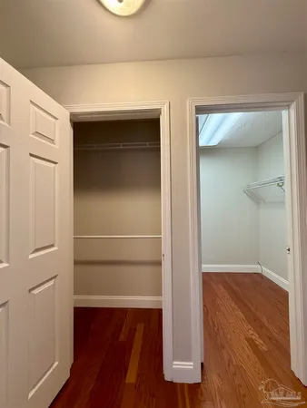 view of empty room with wooden floor and cabinet