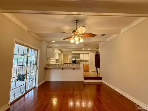 a kitchen with a wooden floor and window