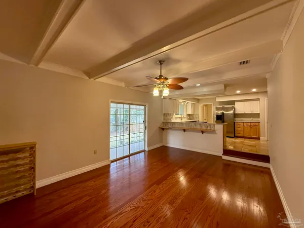 a view of a kitchen with a sink and wooden floor