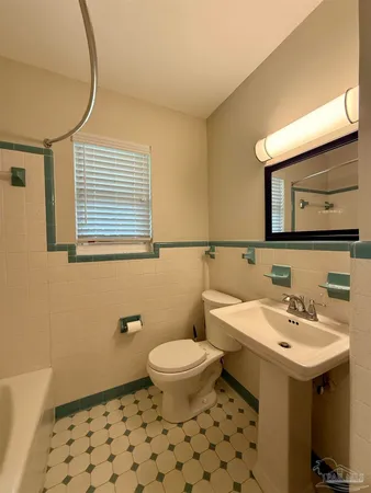 a bathroom with a sink a toilet and mirror