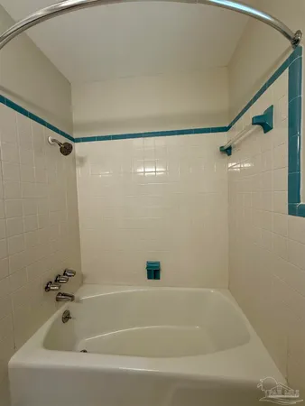 a bathroom with a shower and a bath tub