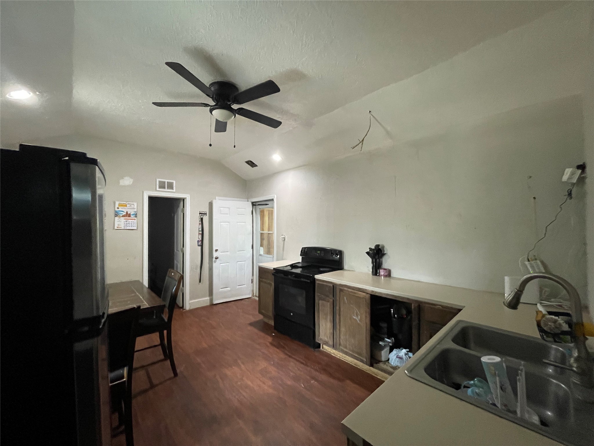 182 Road 5101 Cleveland, TX 77327 - Photo 12 of 35 a kitchen with stainless steel appliances kitchen island a sink stove and refrigerator