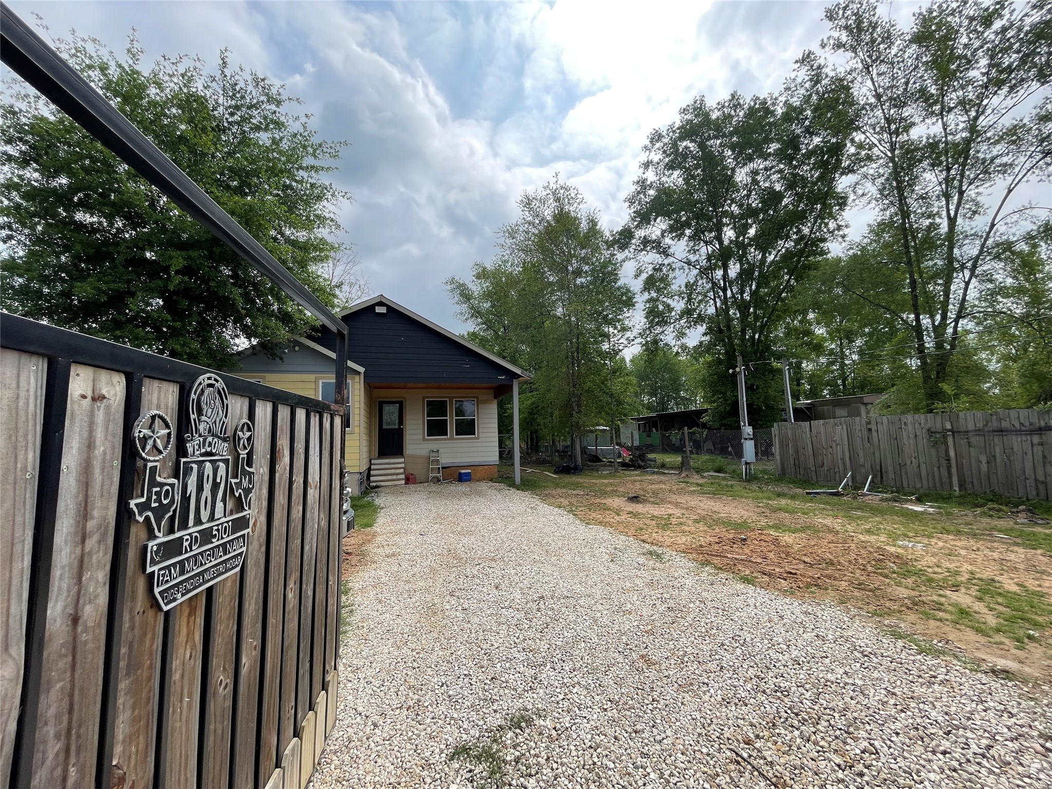 182 Road 5101 Cleveland, TX 77327 - Photo 2 of 35 a view of backyard of house with wooden fence and trees