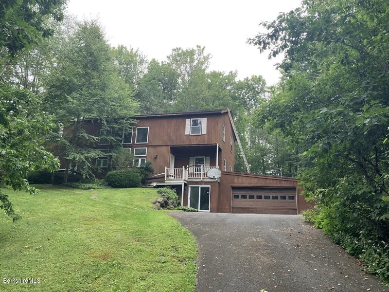 12 Quiet Knoll Road Stockbridge, MA 01266 - Photo 1 of 37 a view of a house with brick walls and a small yard